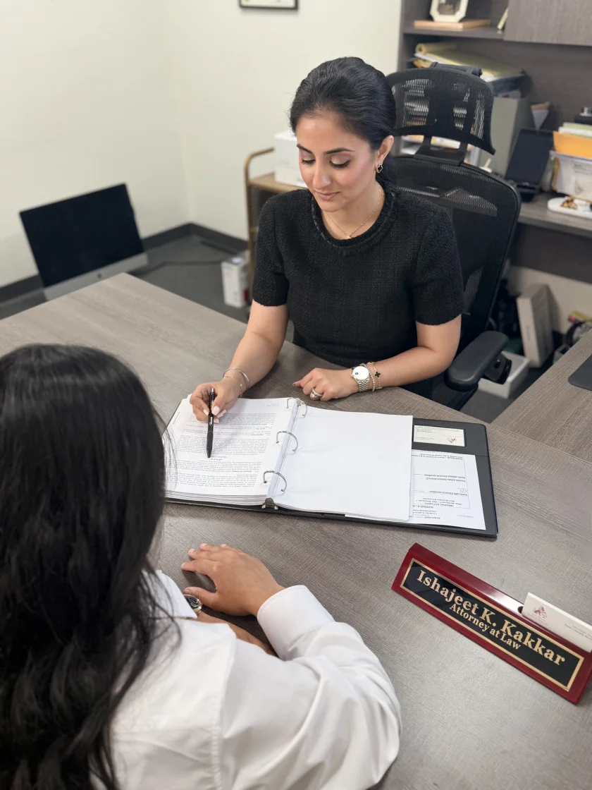 Attorney consulting with a client at a desk